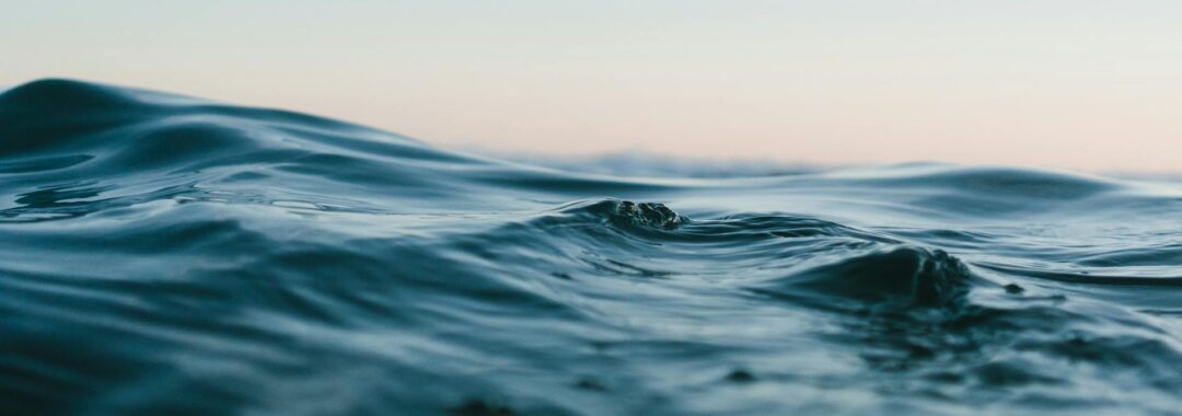 body of water under blue and white skies