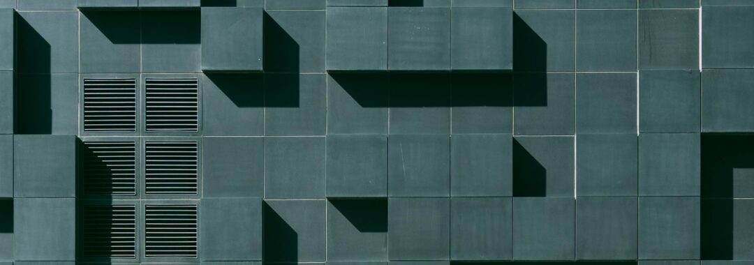 gray concrete building exterior with geometric design