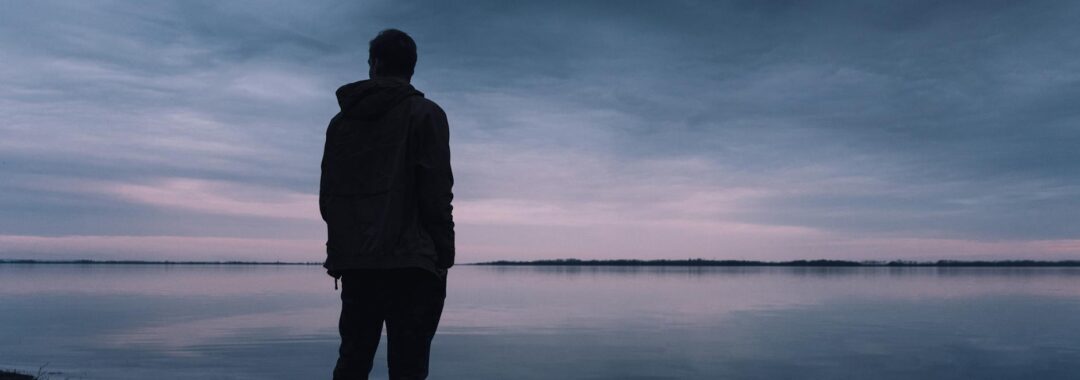 person standing near lake